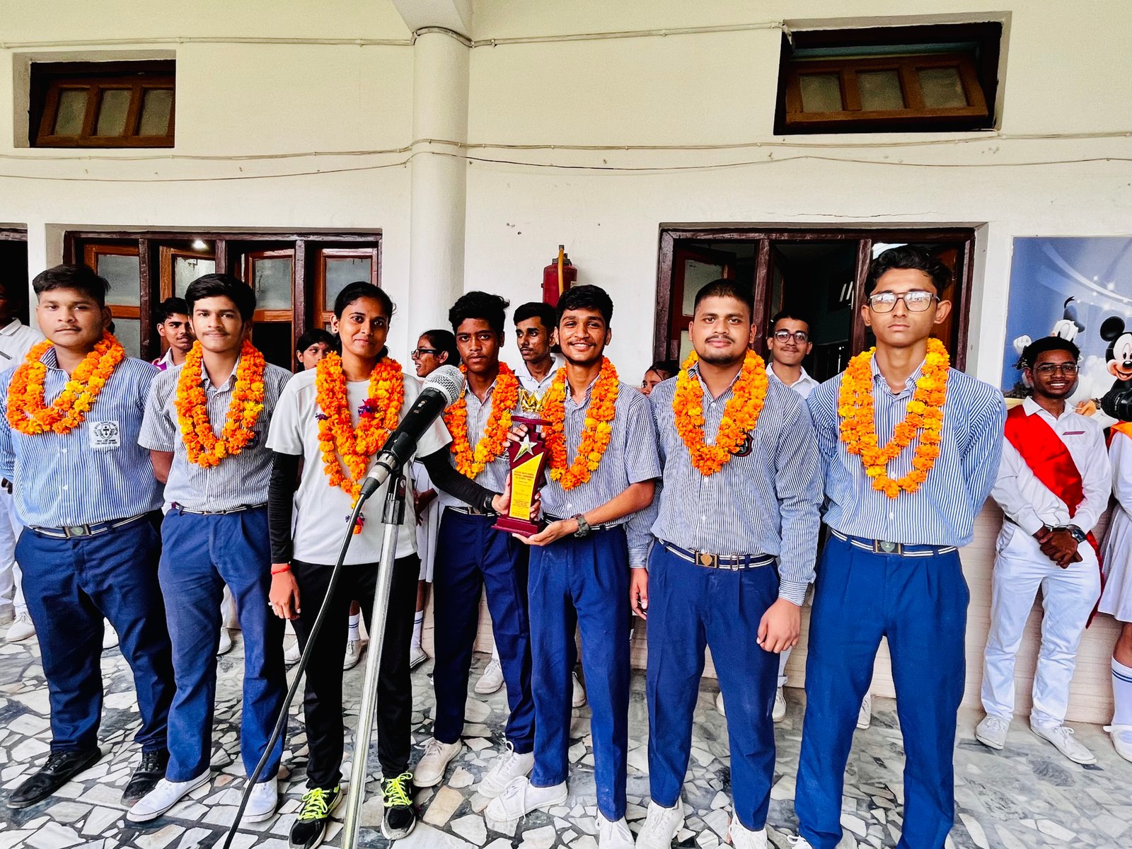 School volleyball team with trophies